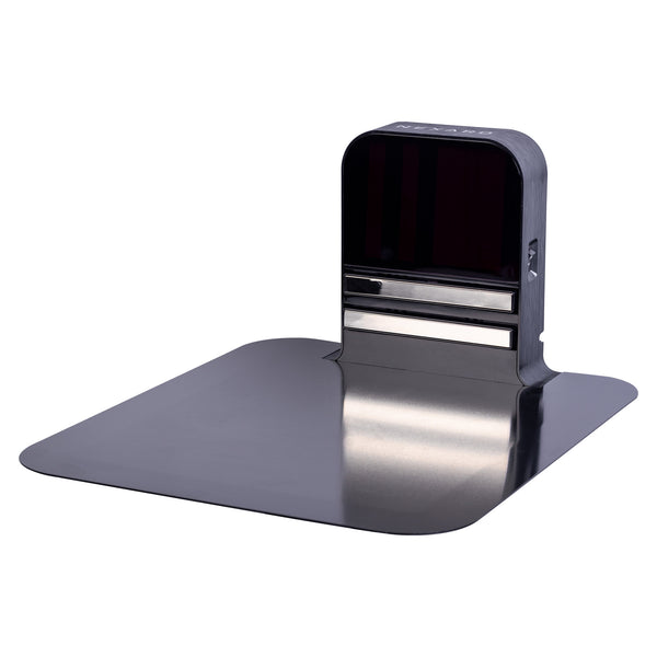 A black, rectangular automatic card shuffler stands on a flat, metallic surface next to a Nexaro NR 1500 charging station including power cord from Nexaro. Power cord from Nexaro.
