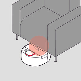 A robot vacuum cleaner stuck under a couch, highlighted by a red circle.