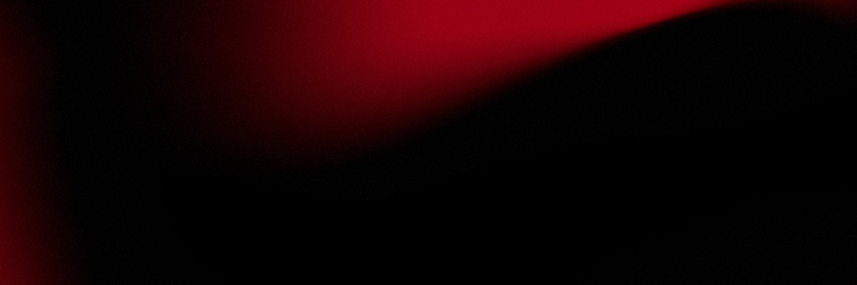 Abstract image with smooth black and red gradient, creating a soft, moody, and mysterious atmosphere.